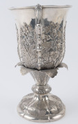 A Chinese Export Silver two-handled presentation cup, with embossed flowers and raised on a shaped circular base with a band of acanthus leaves. By CUTSHING, 8 New China Street, Canton, circa 1853, 26.5cm high, 1630gms. - 7