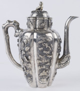 An antique Chinese silver teapot adorned with vignettes of country scenes and floral sprays, Foo dog finial with remains of gilt highlights, 19th century, 18cm high, 17cm wide, 565grams - 4