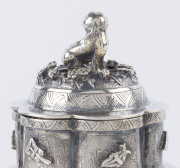 An antique Chinese silver teapot adorned with vignettes of country scenes and floral sprays, Foo dog finial with remains of gilt highlights, 19th century, 18cm high, 17cm wide, 565grams - 7