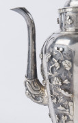 An antique Chinese silver teapot adorned with vignettes of country scenes and floral sprays, Foo dog finial with remains of gilt highlights, 19th century, 18cm high, 17cm wide, 565grams - 9