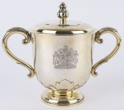 A sterling silver gilt lidded cup by Hardy Brothers, with engraved Royal Coat of Arms and inscribed legend "The Queens Cup - Presented by / Her Majesty Queen Elizabeth II", 20cm high, 885 grams. - 2
