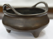 A Chinese cast and patinated bronze censer of squat bowl form with carrying handles, supported on 3 feet, 19th century, impressed mark to the base, 9.5cm high, 16cm diameter - 2