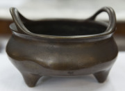 A Chinese cast and patinated bronze censer of squat bowl form with carrying handles, supported on 3 feet, 19th century, impressed mark to the base, 9.5cm high, 16cm diameter - 3