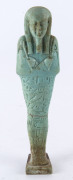 An Egyptian green faience shabti figure, circa 1st - 2nd Century AD, 15cm high - 2