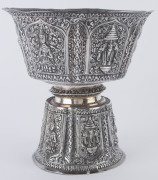 A Laotian silver footed bowl with repousse decorated and alternating panels of the three-headed elephant (airavata) and deities, separated by elaborate floral scrolling and borders with foliate lotus leaf pattern, early 20th century. A silver plaque attac - 2