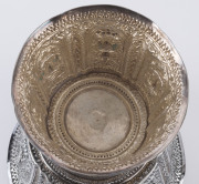 A Laotian silver footed bowl with repousse decorated and alternating panels of the three-headed elephant (airavata) and deities, separated by elaborate floral scrolling and borders with foliate lotus leaf pattern, early 20th century. A silver plaque attac - 8