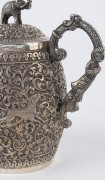 An Indian silver sugar bowl and jug adorned with animals in foliate motif and elephant finials with raised trunks, 19th century, (2 items), 12cm and 15cm high, 890 grams total - 12