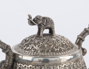 An Indian silver sugar bowl and jug adorned with animals in foliate motif and elephant finials with raised trunks, 19th century, (2 items), 12cm and 15cm high, 890 grams total - 14