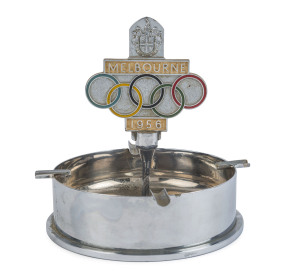 MELBOURNE OLYMPICS: commemorative ashtray, fashioned from a Melbourne 1956 Olympics Car Badge which has been fastened to a base constructed from a WWII Japanese Artillery Shell case.