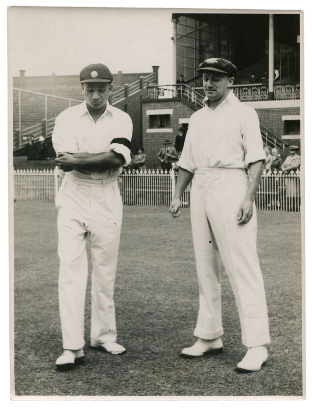 DON BRADMAN - AUSTRALIA vs INDIA, 3rd TEST, MCG, JAN. 1-5, 1948: original press photograph (Melbourne Age), showing Bradman tossing the coin as Indian Captain Lala Armanath looks on; 15.5 x 21cm. The Australians won the Third Test by 233 runs, Bradman sc