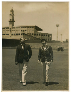 DON BRADMAN - AUSTRALIA vs INDIA, 2nd TEST, SYDNEY, DEC. 12-16, 1947: original press photograph (Sydney Morning Herald), showing Bradman & Indian Captain Lala Armanath looking skyward as they walk out to inspect the wicket; 15.5 x 20.50cm. The Second Test was marred by persistent rainfall, with only 10 hours of play possible over 6 days, the rain-affected wicket resulting in a low-scoring draw.