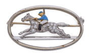 Horse-Racing Brooch: diamond encrusted racehorse in white gold, enamelled jockey, mounted on a oval silver frame, length 3.5cm, weight 6.43gr. Most appealing.