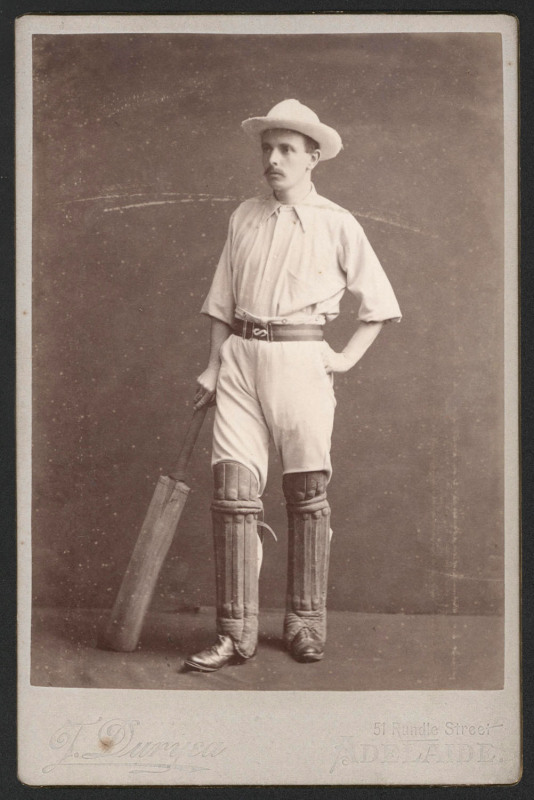 EARLY PHOTOGRAPH OF A CRICKETER: studio photograph by Townsend Duryea (Rundle St, Adelaide) showing a padded-up cricketer posing with bat, 10.5x16.5cm. Good condition. Correction: photograph was taken by Townsend Duryea Junior at his Rundle St studio, be