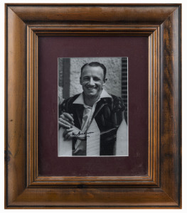 DON BRADMAN: signed photograph (17x12cm) of a smiling Bradman, window mounted, attractively framed & glazed, overall 36x31cm. With Rutherford letter of guarantee stating that the item was purchased at the sale of the Ramamurthy Collection (Christie's, Melbourne, 1997)