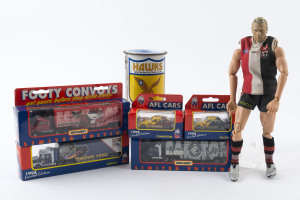 Memorabilia selection with 1998 Matchbox cars (2) with Hawthorn or West Coast Eagles livery and convoy trucks (3) with Adelaide, Carlton or Essendon livery; also Nick Riewoldt (St Kilda) action figure with articulated limbs, and 1976 Hawthorn stubby holder in metal with club song printed on the back. (7 items)