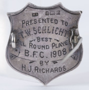 BEAUFORT FOOTBALL CLUB: 9ct gold and sterling silver shield-shaped badge engraved "B.F.C." to front, and verso "PRESENTED TO T.W.SCHLICHT by H.J. RICHARDS - BEST ALL ROUND PLAYER - B.F.C. 1908." - 2