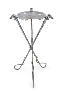 An antique, cast metal horse racing themed table, the legs formed of whips, the table top depicting a horse surrounded by an oversize horse shoe; also,a wall-mounted coat rack with similar imagery, late 19th century, (2 items).