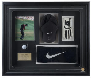 TIGER WOODS: visually impressive display comprising Nike golf cap signed by Woods, plus Nike brand glove, golf ball and towel, also a colour photograph of Woods putting for his second consecutive Masters win in 2002, Superstars & Legends CofA; window moun