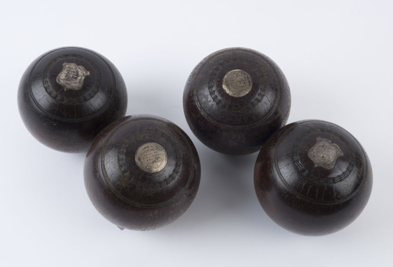 LAWN BOWLS: two 1908 and two 1909 Lignum Vitae presentation lawn bowls for Cheltenham Bowling Club with engraved silver plaques. (4)