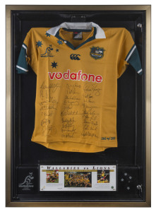 WALLABIES: 2001 "Wallabies v Lions" commemorative jersey signed by the entire Wallaby squad, jersey unwrapped within a lockable framed perspex box, limited edition number #200 of 200; Price Waterhouse Coopers authenticated CofA; overall 85x116x10cm.