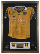 WALLABIES: 2001 "Wallabies v Lions" commemorative jersey signed by the entire Wallaby squad, jersey unwrapped within a lockable framed perspex box, limited edition number #200 of 200; Price Waterhouse Coopers authenticated CofA; overall 85x116x10cm.