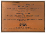 AUSTRALIA v ENGLAND 1977 ASHES CENTENARY: commemorative brass plaque (61x46cm) presented to the Windsor Hotel by North Melbourne Cricket Club (12 March 1977), mounted on wooded frame; overall 65x50cm. Ex 'The Cricketers Bar', Windsor Hotel, Melbourne.