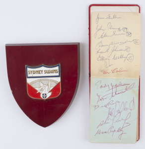 SOUTH MELBOURNE - AUTOGRAPH BOOK: with approximately 60 signatures of early 1960s players including Max Papley, Bobby Kingston, Bill Ross, Ken Colvin, Des Bethke, Graeme John & John Rantall; some are duplicated; also Sydney Swans crest mounted on a wooden