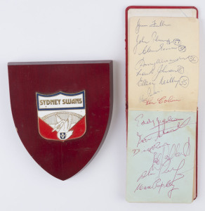 SOUTH MELBOURNE - AUTOGRAPH BOOK: with approximately 60 signatures of early 1960s players including Max Papley, Bobby Kingston, Bill Ross, Ken Colvin, Des Bethke, Graeme John & John Rantall; some are duplicated; also Sydney Swans crest mounted on a wooden plaque. (2 items).