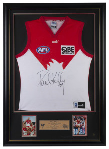 PAUL KELLY - SYDNEY SWANS: AFL limited edition display, commemorating Kelly's 200th game, with signed guernsey and two inset photographs of Kelly and a commemorative plaque; numbered #55 of 200; framed & glazed, overall 76x107cm.