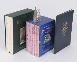 "The Bradman Albums" cased set of 2 volumes; "Australian Cricket" the 5 volume boxed set by Pollard; "World Championship of Cricket" by Steele and a small cricket-themed desk clock. 