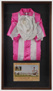 MANIKATO: silks & jockey's cap, window mounted with race finish photograph of the 1980 Futurity Stakes, signed by Roy Higgins, framed & glazed, overall  96 x 53cm.
