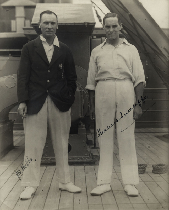 JACK HOBBS & HERBERT SUTCLIFFE, fine pen signatures on original photograph of the pair on board ship while en route to Australia, window mounted, framed & glazed, overall 38x45cm.The England cricket team toured Australia in 1928–29. England retained The A