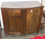 A Georgian bow front two door cabinet with book-matched flame mahogany panels, brass reeded trim and unusual vertical fluted edge, circa 1800, 86cm high, 97cm wide, 54cm deep - 2