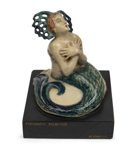 MARGUERITE MAHOOD pottery mermaid statue on original ebonized wooden base, titled "Forsaken Mermaid", circa 1936, incised "Marguerite Mahood" and titled on the plinth, 15.5cm high overall, 13.5cm wide, 13.5cm deep. Illustrated in "AUSTRALIAN ART POTTERY 