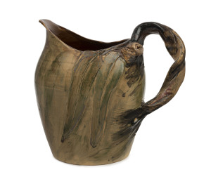 REMUED early pottery jug with applied branch handle gumnuts and leaves with hand-painted finish, incised "Remued,1933", 17.5cm high, 19cm wide
