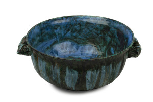 JOHN PERCEVAL & ARTHUR MERRIC BOYD large pottery bowl adorned with moulded and striated gum leaves and two stylised stumpy tail lizard handles, glazed in shades of green and blue, incised "Perceval, M.B. 1957", 17.5cm high, 48cm wide
