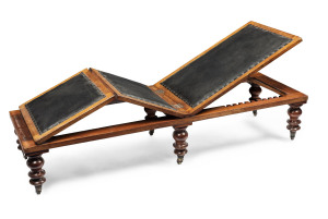 A rare Colonial folding daybed, Australian cedar and leather with vase turned baluster legs on original brass castors, Sydney, New South Wales origin, mid 19th century, 37cm high, 187cm wide, 61cm deep