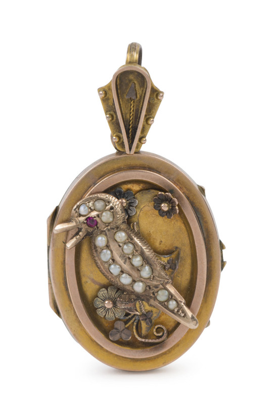 An antique Australian gold locket adorned with raised kookaburra set with ruby and seed pearls, late 19th early 20th century, ​4.5cm high, 7.5 grams total