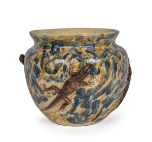 An Australian pottery jardinière with applied lizards, incised "T.M. 1918", 24cm high, 28cm wide