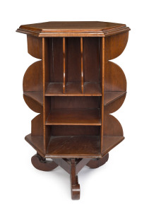 An antique Australian revolving hexagonal bookstand, solid cedar construction on scrolling tri-form base with rolling brass castor mechanism, 19th century, 104cm high, 72cm wide.