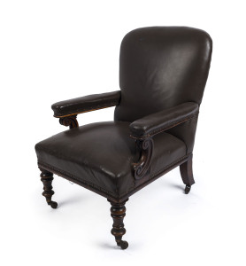 A Colonial library chair with splayed and ring turned legs, carved scroll arm supports, Australian cedar with brown leather upholstery, mid 19th century, 92cm high, 64cm across the arms