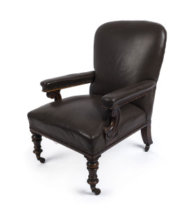 A Colonial library chair with splayed and ring turned legs, carved scroll arm supports, Australian cedar with brown leather upholstery, ​mid 19th century, 92cm high, 64cm across the arms
