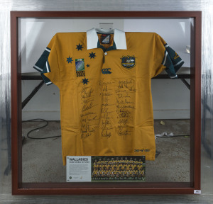 WALLABIES - 2003 WORLD CUP: commemorative team jersey hand signed by entire Wallabies World Cup squad, displayed in lockable framed perspex box, limited edition of 400, with Price Waterhouse Coopers authenticated CofA; overall 79x104x11cm.