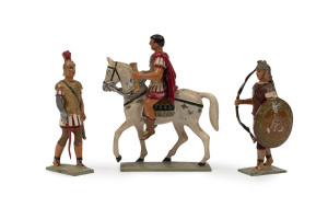 MASTERPIECES IN MINIATURE: Solid Cast Lead Figures of Roman Legionnaires (4) comprising three marching figures - two with shields, one with a wolf's headdress - plus a legionnaire on horseback, all with descriptive inscription and M.I.M. maker's mark on b