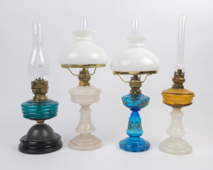 Four coloured and moulded glass kerosene lamps, early 20th century, (4 items), the largest 56cm high