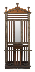 An antique folk art hallstand, carved timber with brass hooks and rails, 20th century, 125cm high, 95cm wide, 40cm deep
