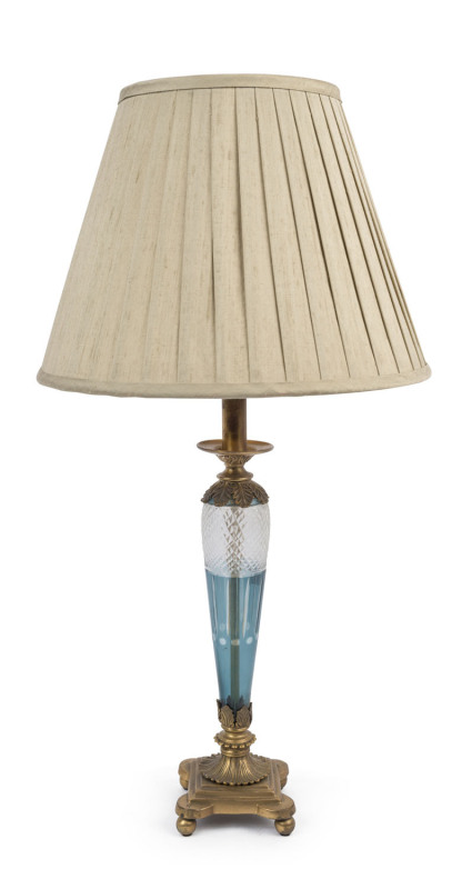 A Bohemian table lamp and shade, blue overlay cut crystal with ormolu mounts and pleated silk shade, late 20th century, 75cm high