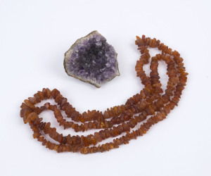 A graduated raw amber necklace and geode crystal sample, early 20th century, the geode 8cm high, 8cm wide