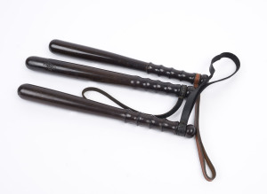 Three lignum vitae police truncheons, all with ring turned hand grips and leather lanyards, 20th century, the largest 40cm long