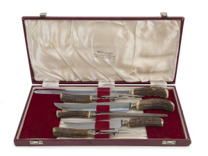 "Wostenholm's" Sheffield England boxed set of carving utensils, comprising of 3 knives, 1 sharpening steel and 2 carving forks, stainless steel with sterling silver collars and antler handles, early 20th century, the box 47cm wide, 22cm deep